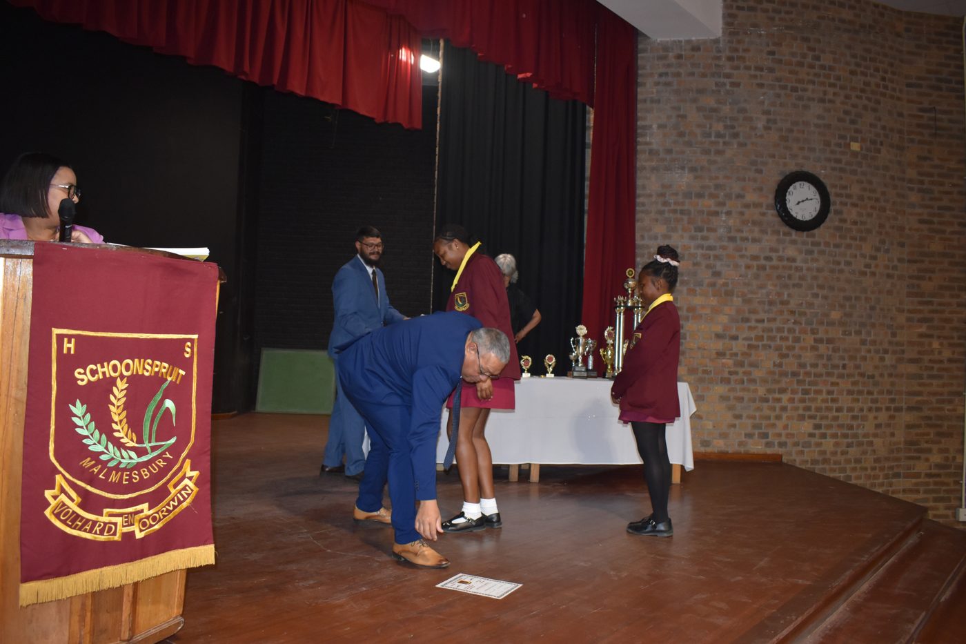 Learner receiving a trophy on stage at the school's prize-giving ceremony