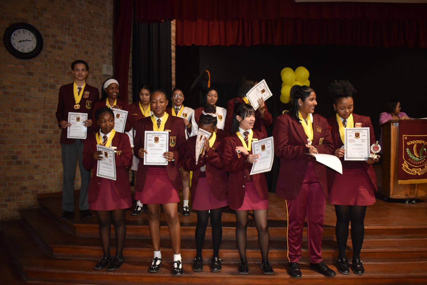 Group of learners with certificates and medals at prize-giving